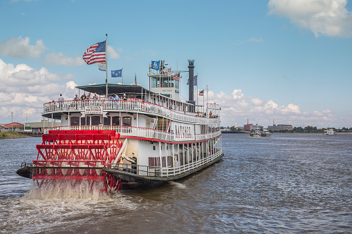 Steamer Natchez along the Mississippi River in New Orleans. The 9th Natchez to be built serves as a tourist cruise boat along the Mighty Mississippi. A popular tourist activity in New Orleans is to cruise on a steamboat along the Mississippi River.