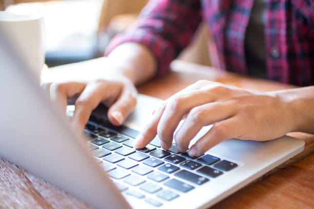istock Close-up of female student typing on laptop at table 687128080