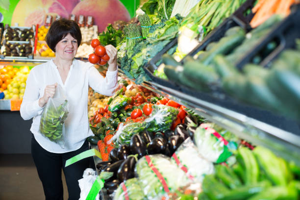 istock Mature woman buying fresh vegetables 687139084