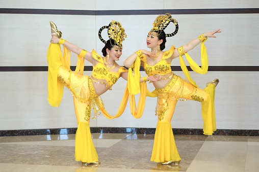 two beautiful girl actres in yellow traditional chinese stage costumes