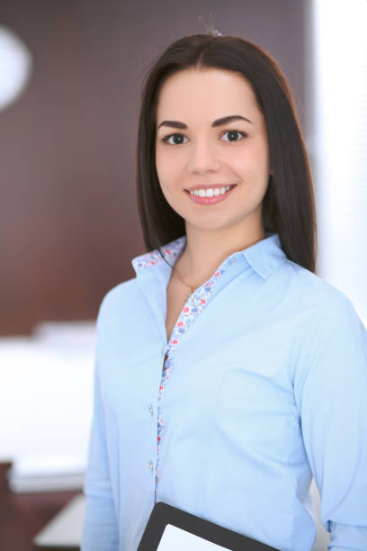 istock Young business woman standing in office 687142578