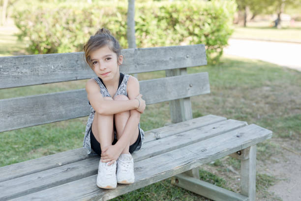 istock Girl sitting on a wooden bench 687143952