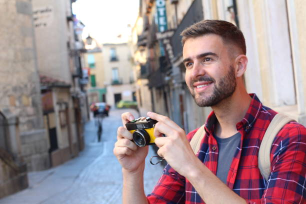 istock Handsome traveler about to take a photograph 687151660