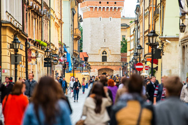 Crowd of anonymous people walking on a busy street. Krakow, Old Town, Poland.