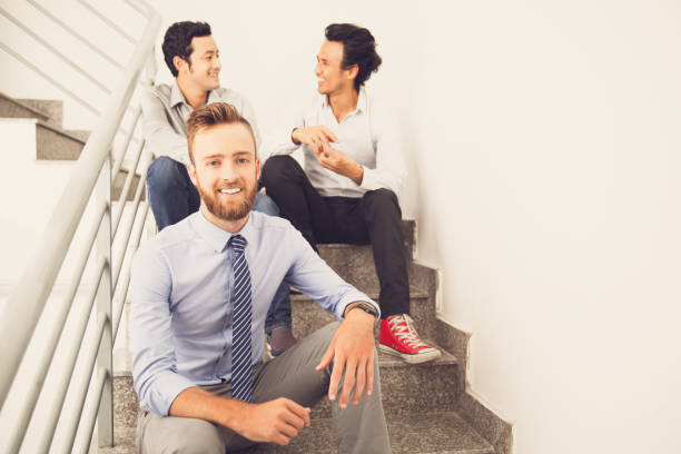 istock Smiling business friends resting on stairs_tone 687155564