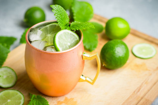 istock Cold Moscow Mule cocktail in copper mug on the rustic background 687155846