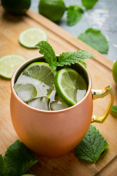 istock Cold Moscow Mule cocktail in copper mug on the rustic background 687155878