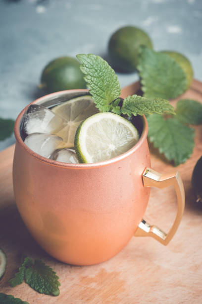 istock Cold Moscow Mule cocktail in copper mug on the rustic background 687155896