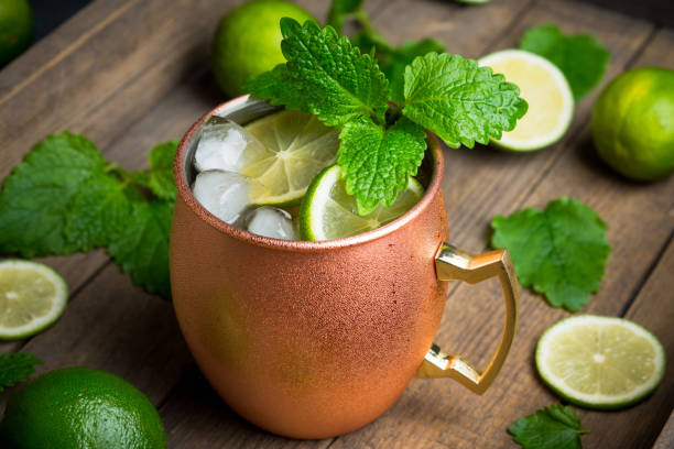 istock Cold Moscow Mule cocktail in copper mug on the rustic background 687155910