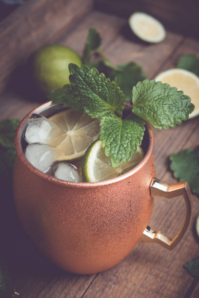 istock Cold Moscow Mule cocktail in copper mug on the rustic background 687155918