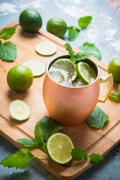 istock Cold Moscow Mule cocktail in copper mug on the rustic background 687155924