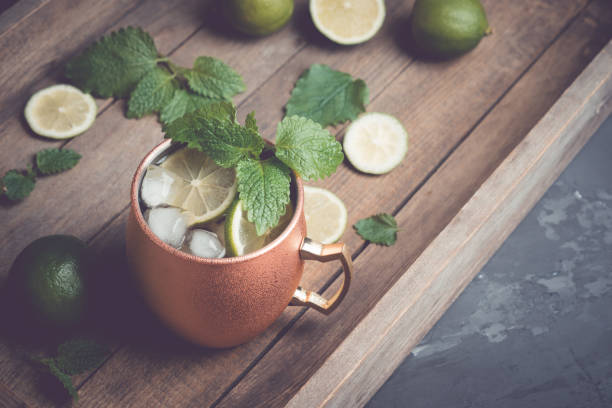 istock Cold Moscow Mule cocktail in copper mug on the rustic background 687155934