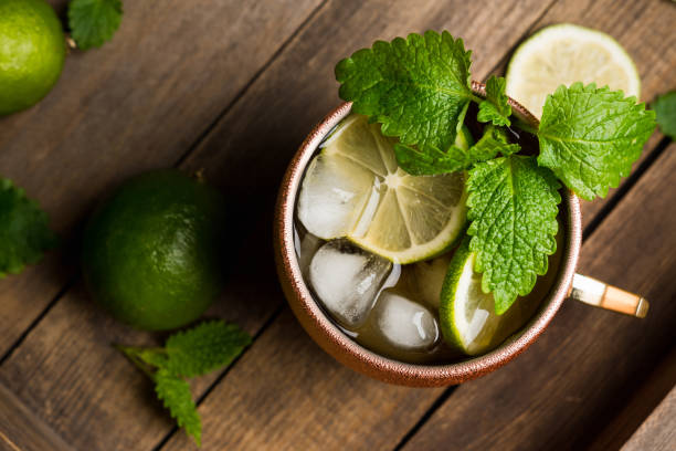 istock Cold Moscow Mule cocktail in copper mug on the rustic background 687155960