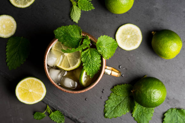 istock Cold Moscow Mule cocktail in copper mug on the rustic background 687155986