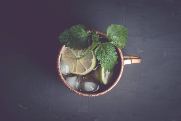 istock Cold Moscow Mule cocktail in copper mug on the rustic background 687156002