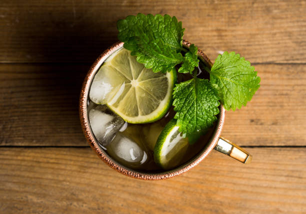 istock Cold Moscow Mule cocktail in copper mug on the rustic background 687156024