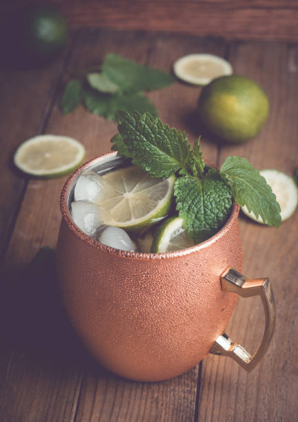 istock Cold Moscow Mule cocktail in copper mug on the rustic background 687156074