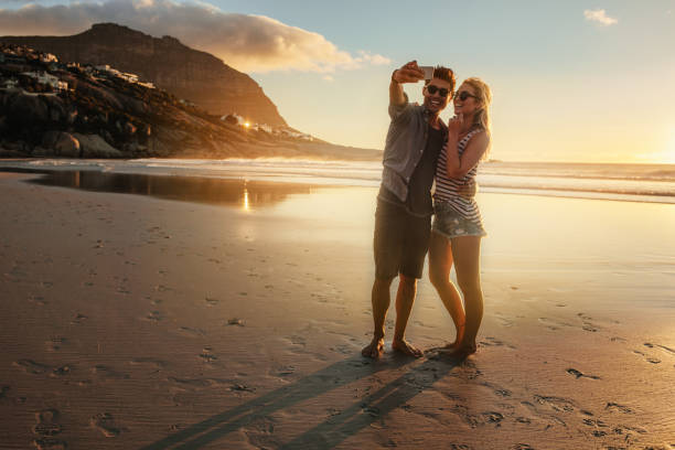 istock Romantic young couple taking selfie at the beach 687159298