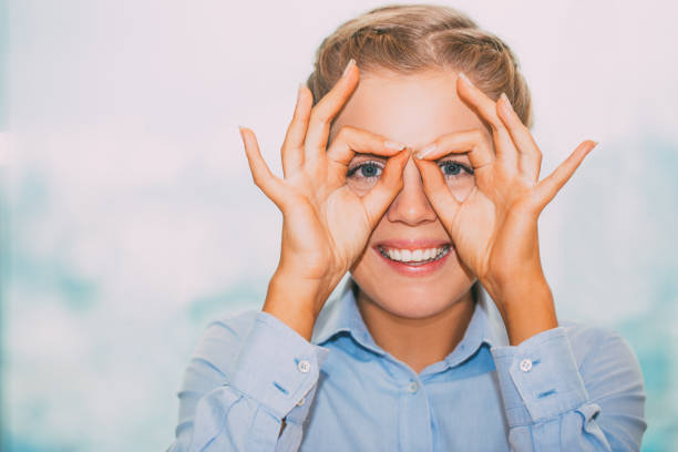 istock Closeup of Woman Looking through Binoculars Hands 687159562
