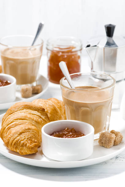 istock coffee with milk and croissants with jam on white table 687162438