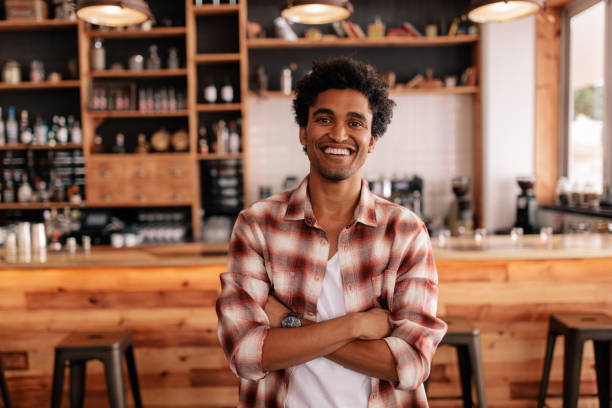 istock Handsome young man with his arms crossed in a cafe 687163460