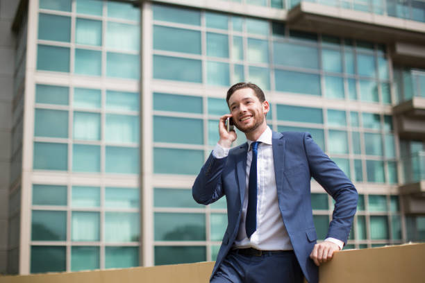 istock Smiling Business Man Talking on Phone Outdoors 687166366