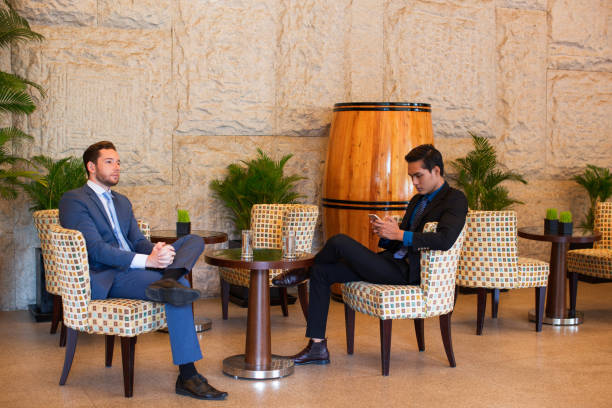 Two Middle-aged Business Men Having Rest in Cafe