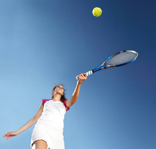 istock woman tennis player with racket during a match game, isolated 687170846