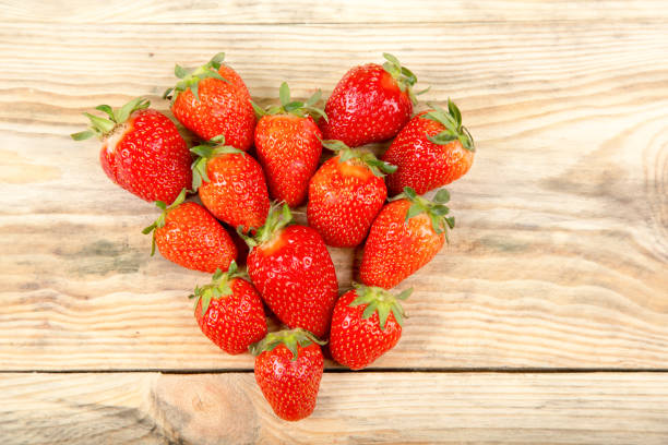 istock Ripe strawberry on a wooden background 687174366