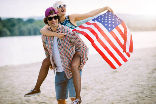 istock Couple on the beach with US flag 687174608