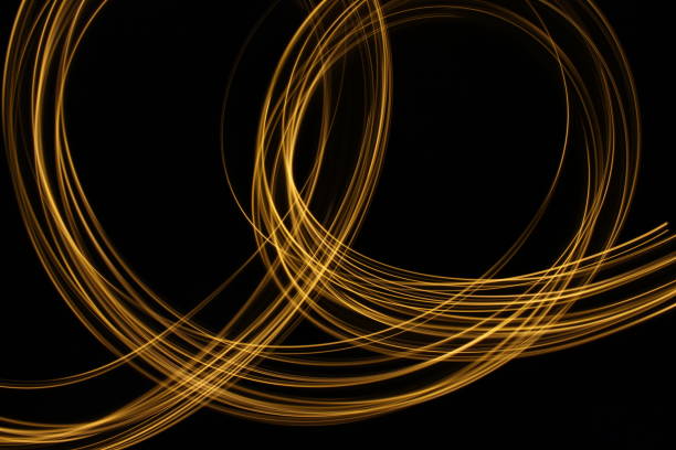istock Gold Light Painting Photography against a black background 687175014