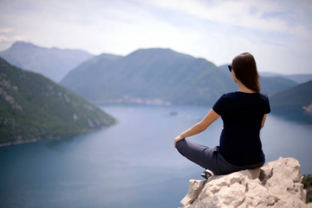 istock young woman enjoying in meditation and beautiful view 687180232