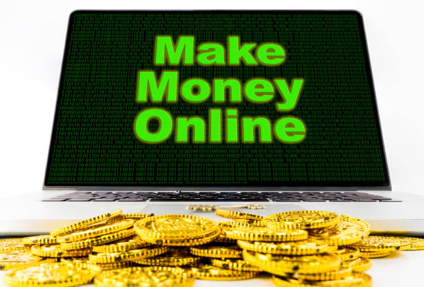 istock Make money online on computer screen with golden coins. 687180556