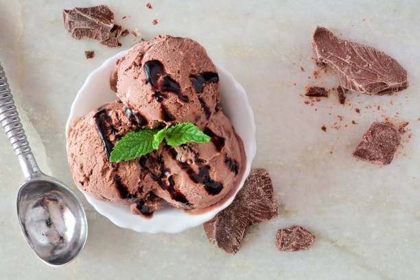 istock Bowl of chocolate ice cream, above scene over white marble 687180712