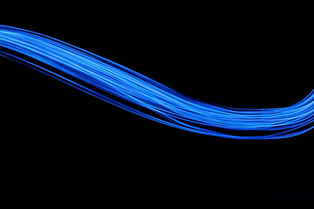 istock Blue Light Painting Photography, smooth line patterns against a black background 687180776