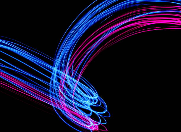 istock Blue and Pink Light Painting Photography, smooth line patterns against a black background 687181032