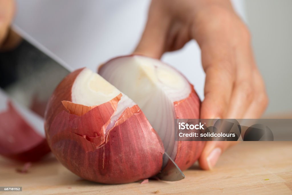 Chopping Onion Woman chopping onion, close up. Onion Stock Photo