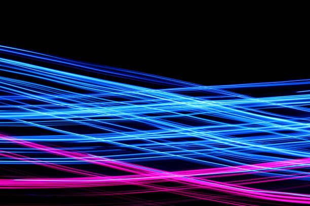 istock Blue and Pink Light Painting Photography, smooth line patterns against a black background 687181264