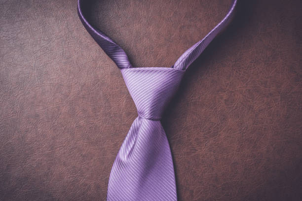 istock Purple necktie on elegant leather background 687193568