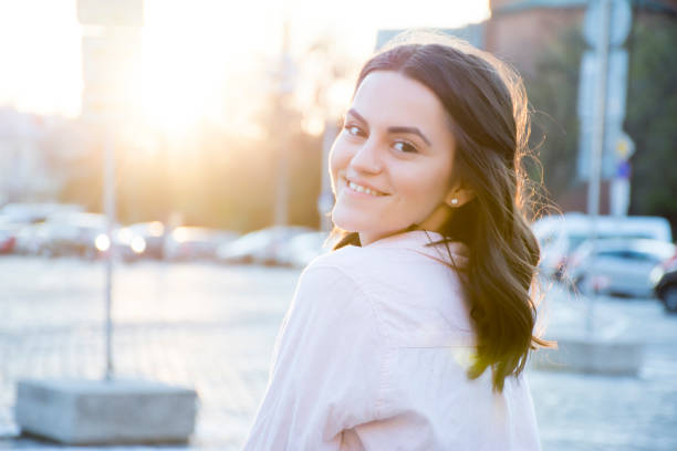 istock Young smiling woman in city 687196838