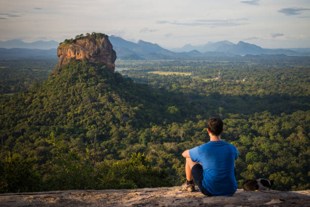 istock Young man looking at the Sigiriya Rock 687197388