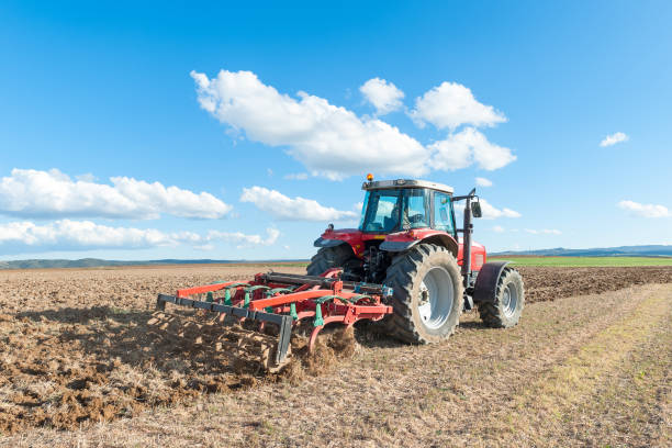istock tractor in the lands along with gear for work 687199498