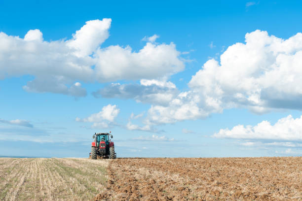 istock tractor in the lands along with gear for work 687199608