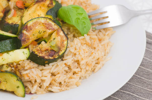 Vegan meal consisting of risotto with vegetables served on a plate.