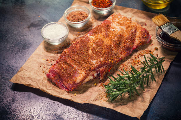 Fresh Raw Pork Ribs Preparing fresh raw spareribs for barbecue marinade stock pictures, royalty-free photos & images