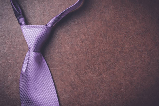 istock Purple necktie on elegant leather background 687200766