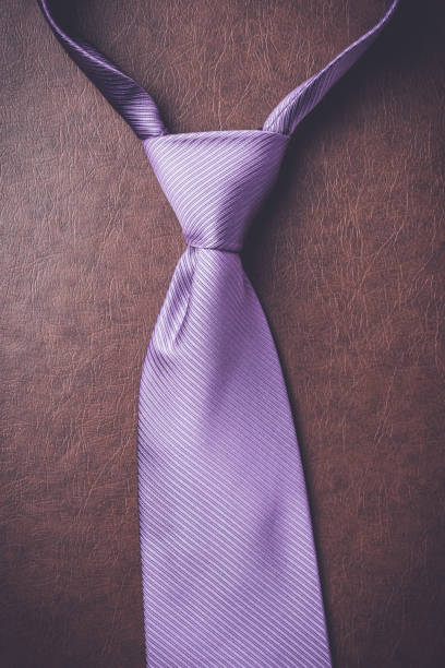 istock Purple necktie on elegant leather background 687203028