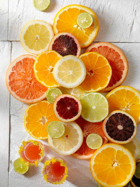 Citrus Slices with Cocktails Group of citrus slices,oranges, bloody oranges,limes,lemons,key limes and grapefruit citrus fruit stock pictures, royalty-free photos & images