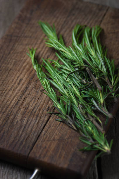 istock Rosemary bunch on wooden background 687206200