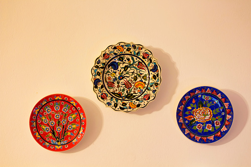 Decorative ceramic plates on beige wall. Traditional Turkish - Ottoman floral motives and patterns are applied.